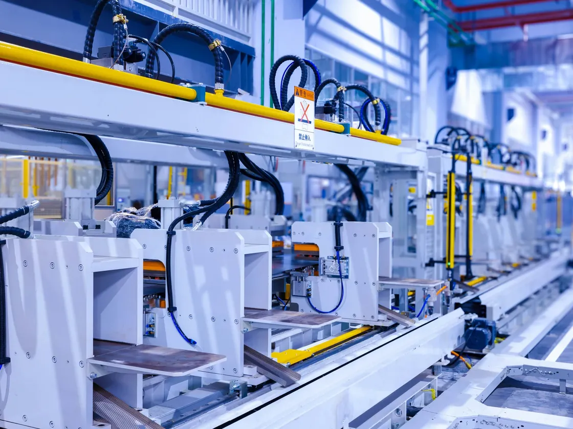 Automated assembly stations and conveyors in a refrigerator production facility.